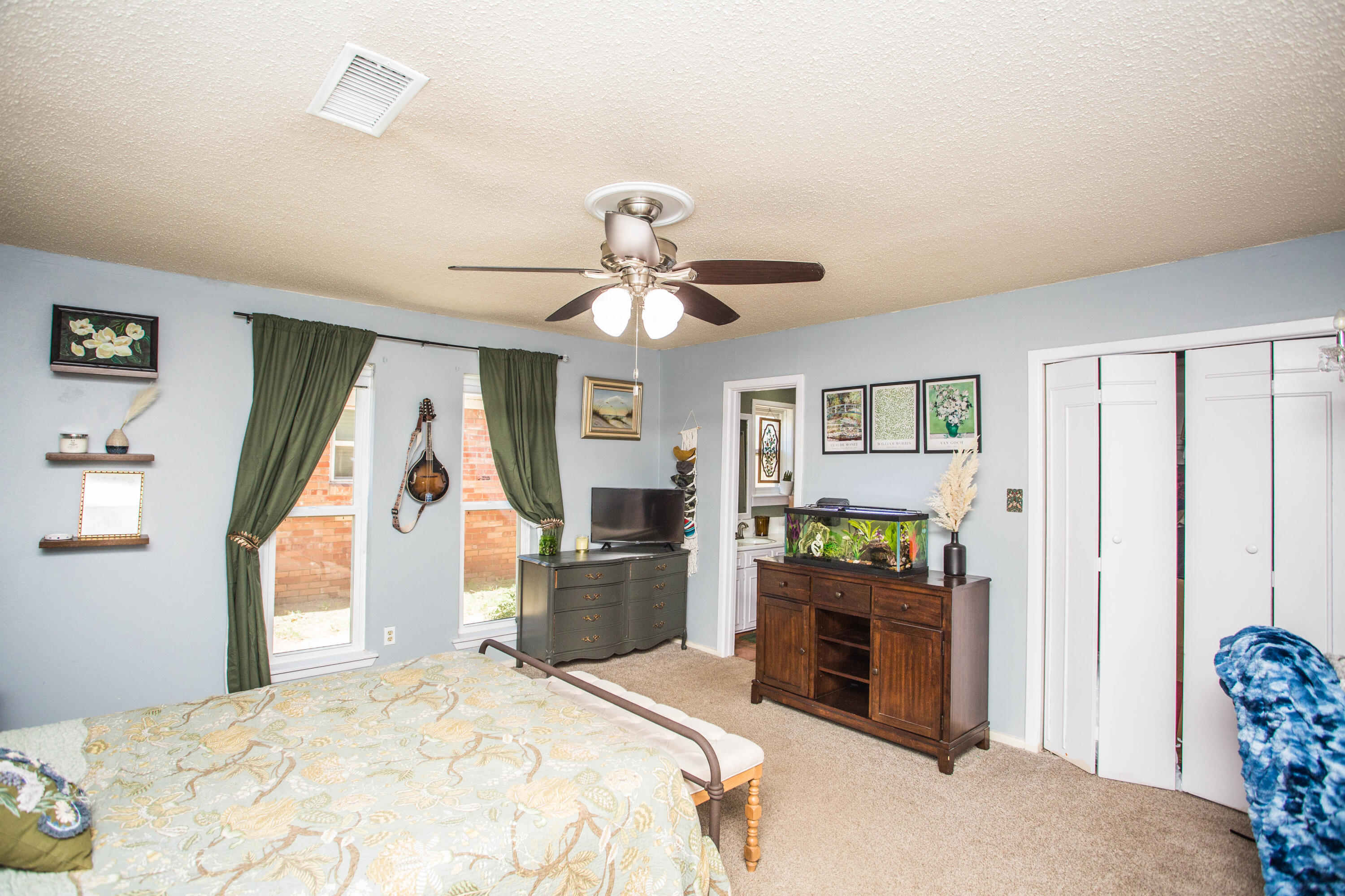5202 44th Street Lubbock, TX 79414 - Photo 24 of 51 a bedroom with a bed and a chandelier