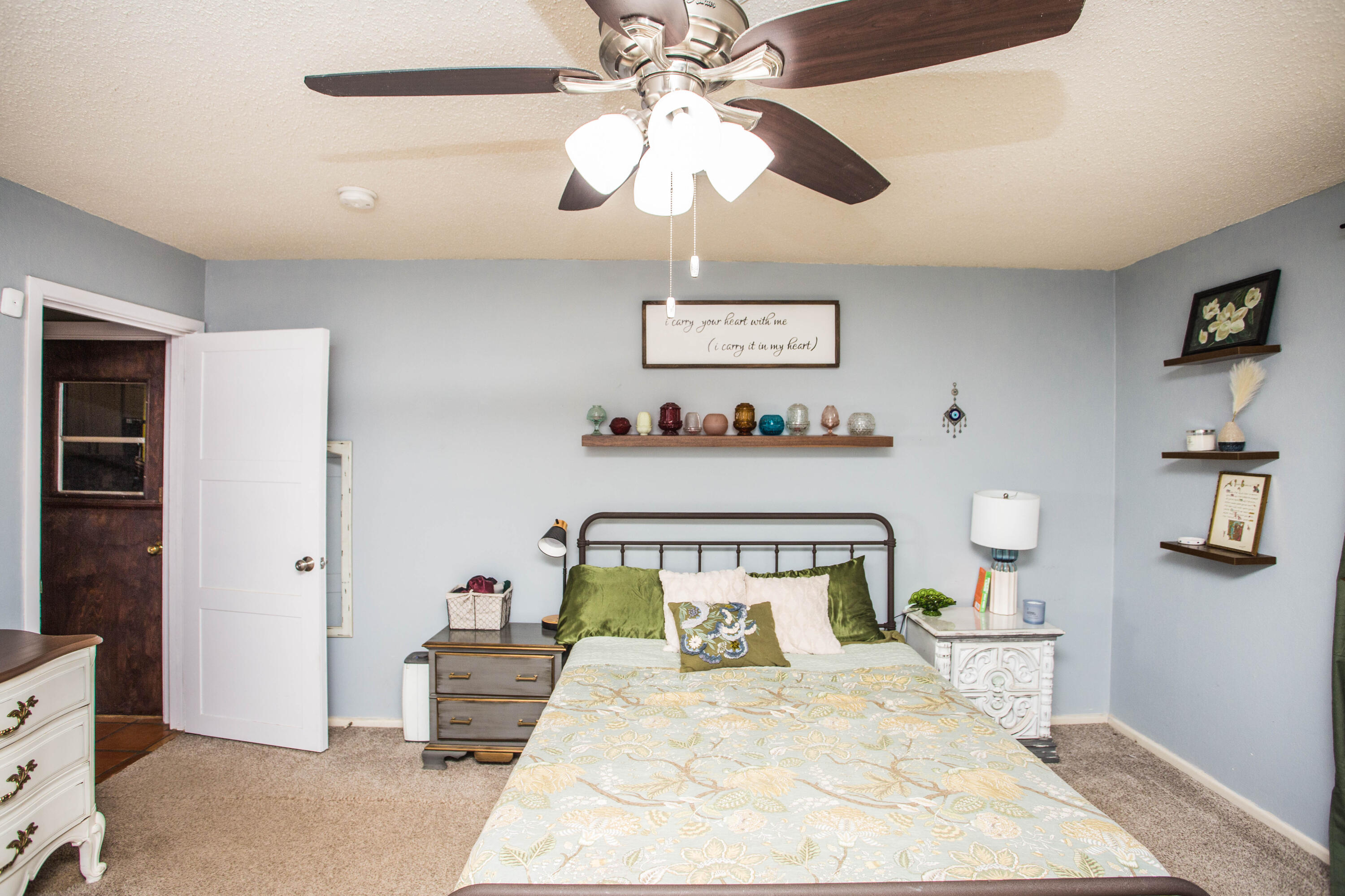 5202 44th Street Lubbock, TX 79414 - Photo 26 of 51 a bedroom with a bed and a chandelier