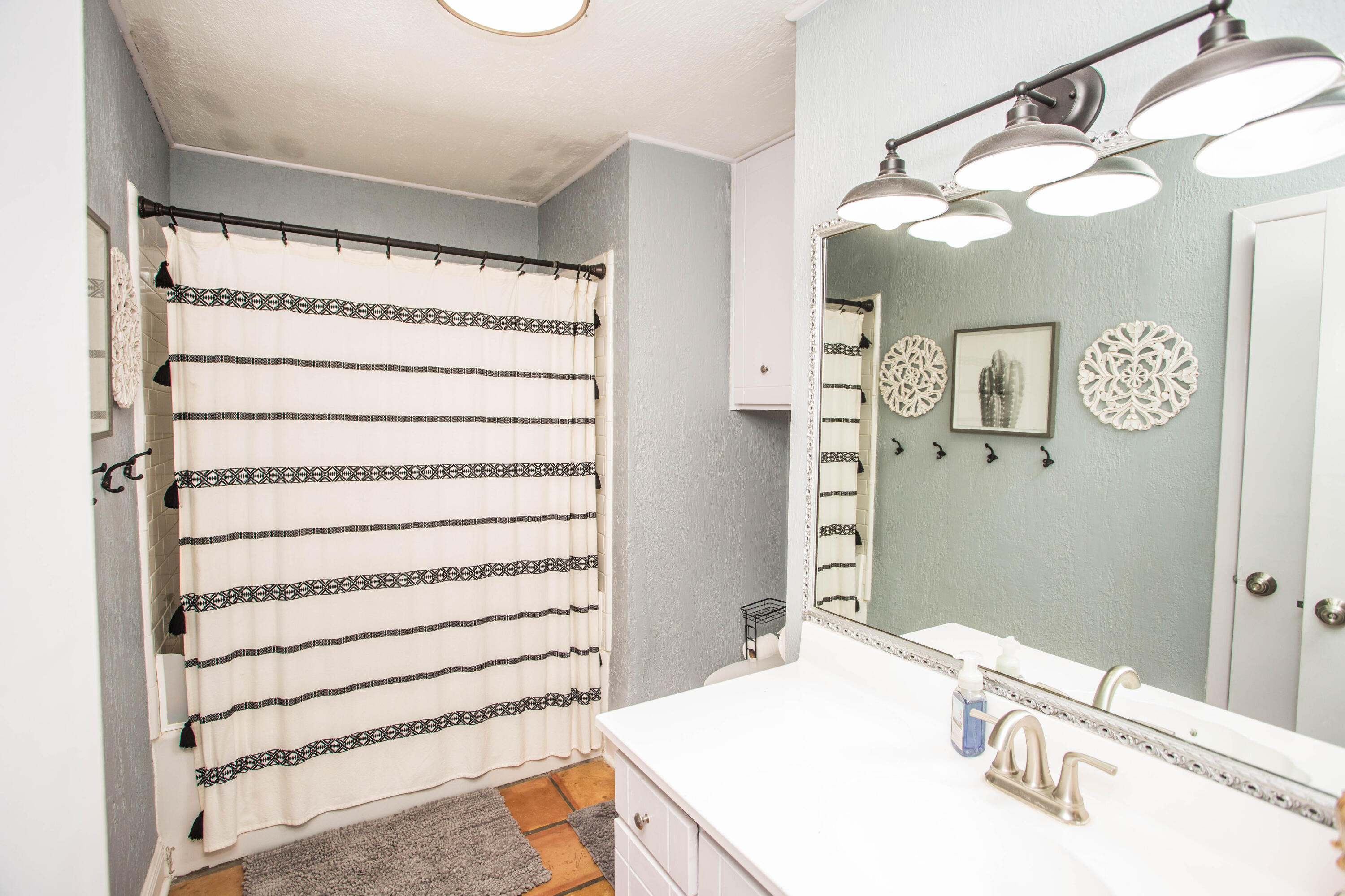 5202 44th Street Lubbock, TX 79414 - Photo 32 of 51 a bathroom with a sink and a mirror