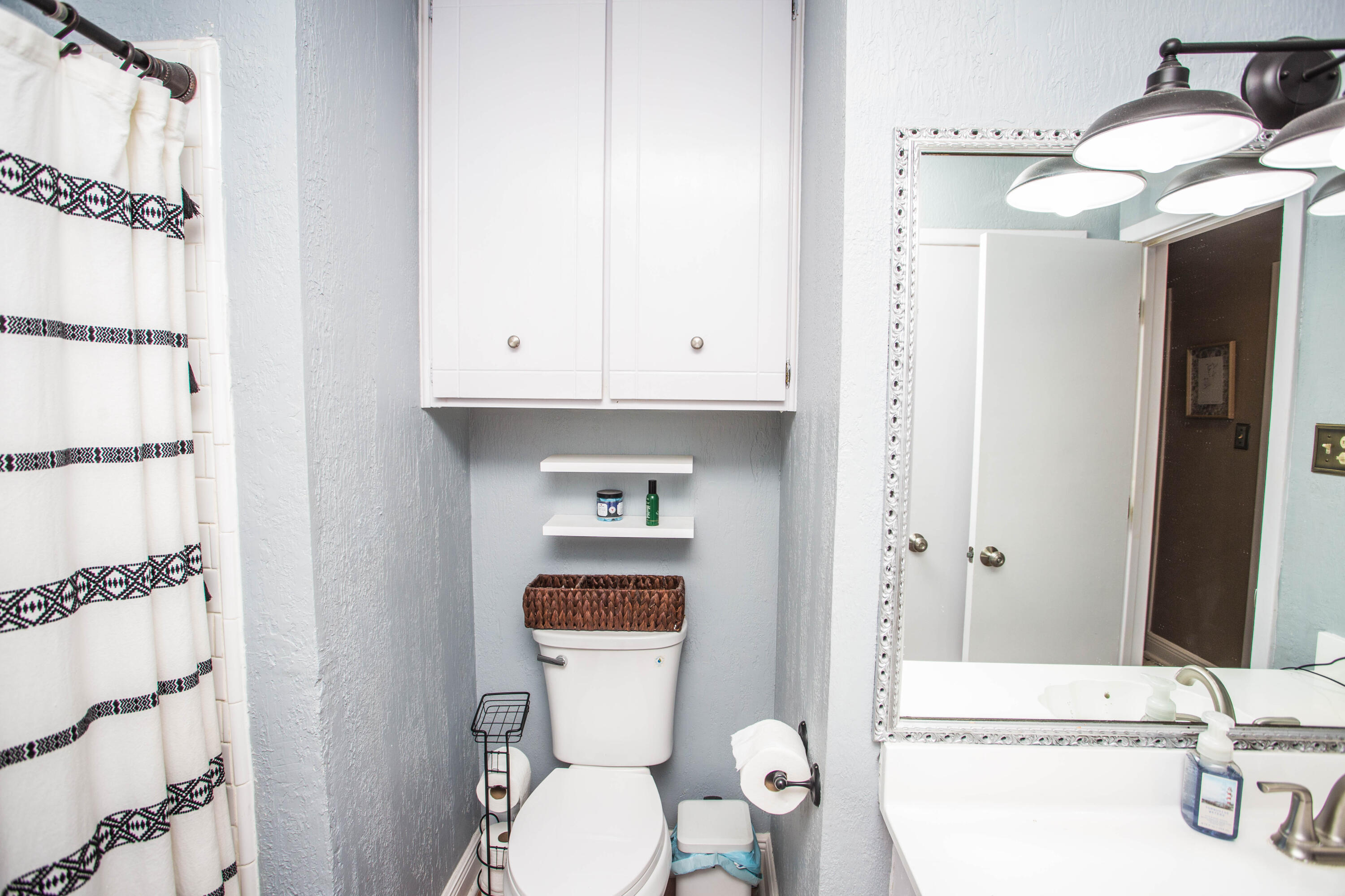 5202 44th Street Lubbock, TX 79414 - Photo 34 of 51 a bathroom with a sink a toilet and shower
