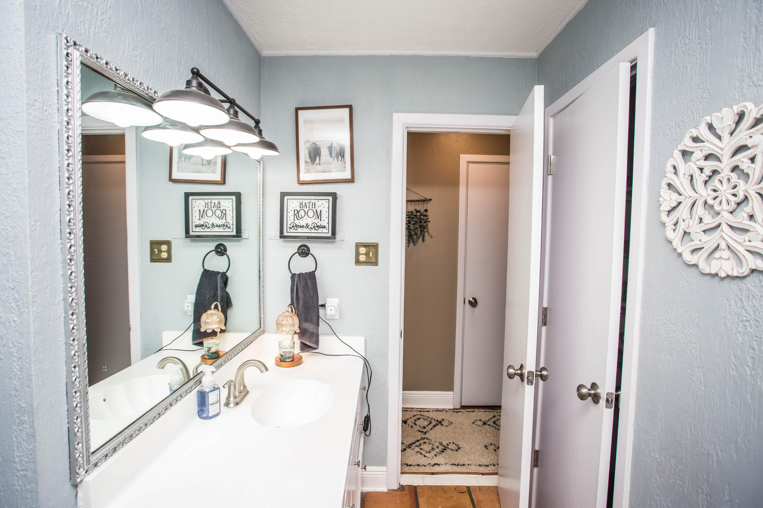 5202 44th Street Lubbock, TX 79414 - Photo 35 of 51 a bathroom with a sink vanity and mirror