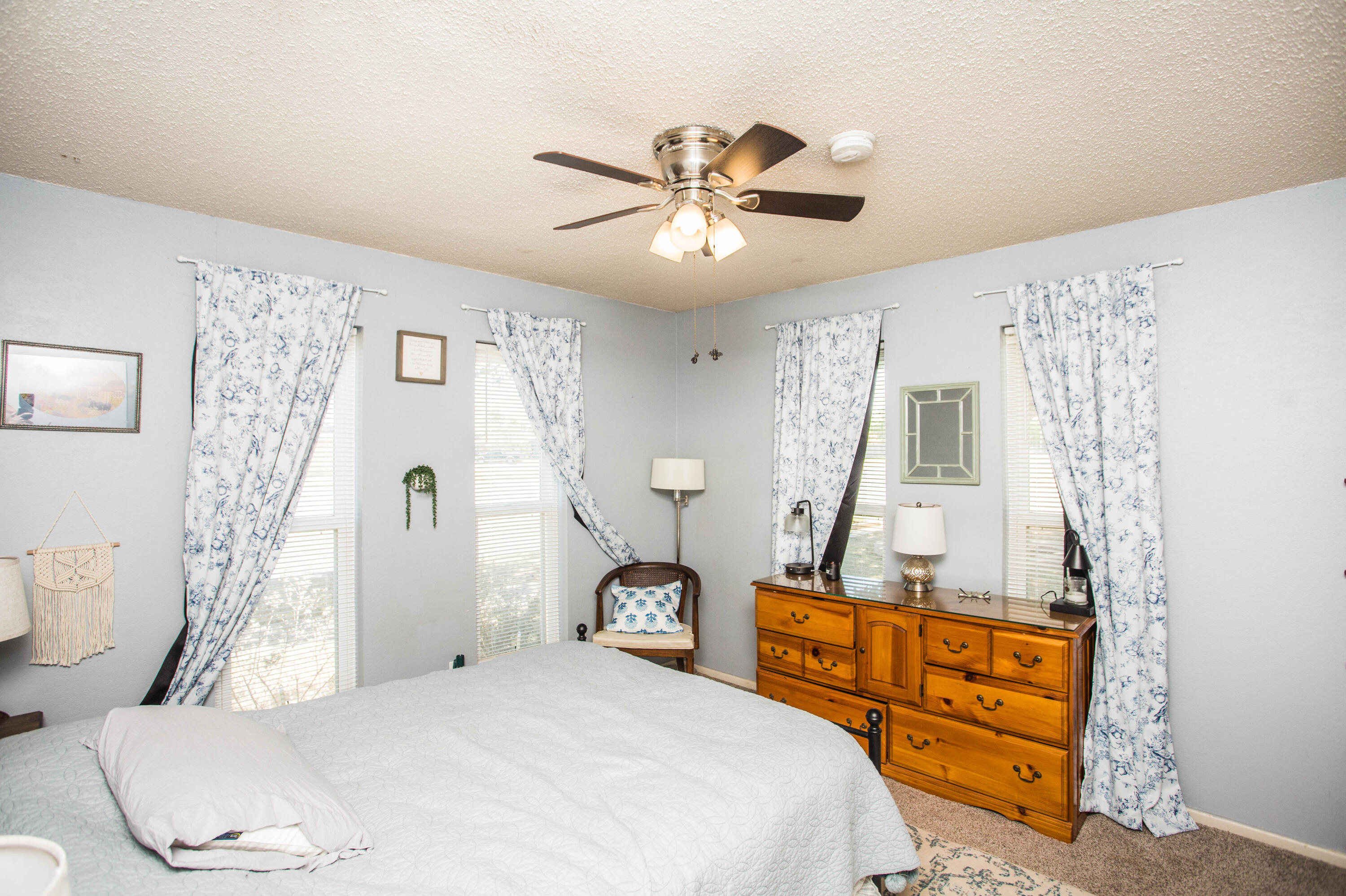 5202 44th Street Lubbock, TX 79414 - Photo 36 of 51 a bedroom with a bed and a chandelier