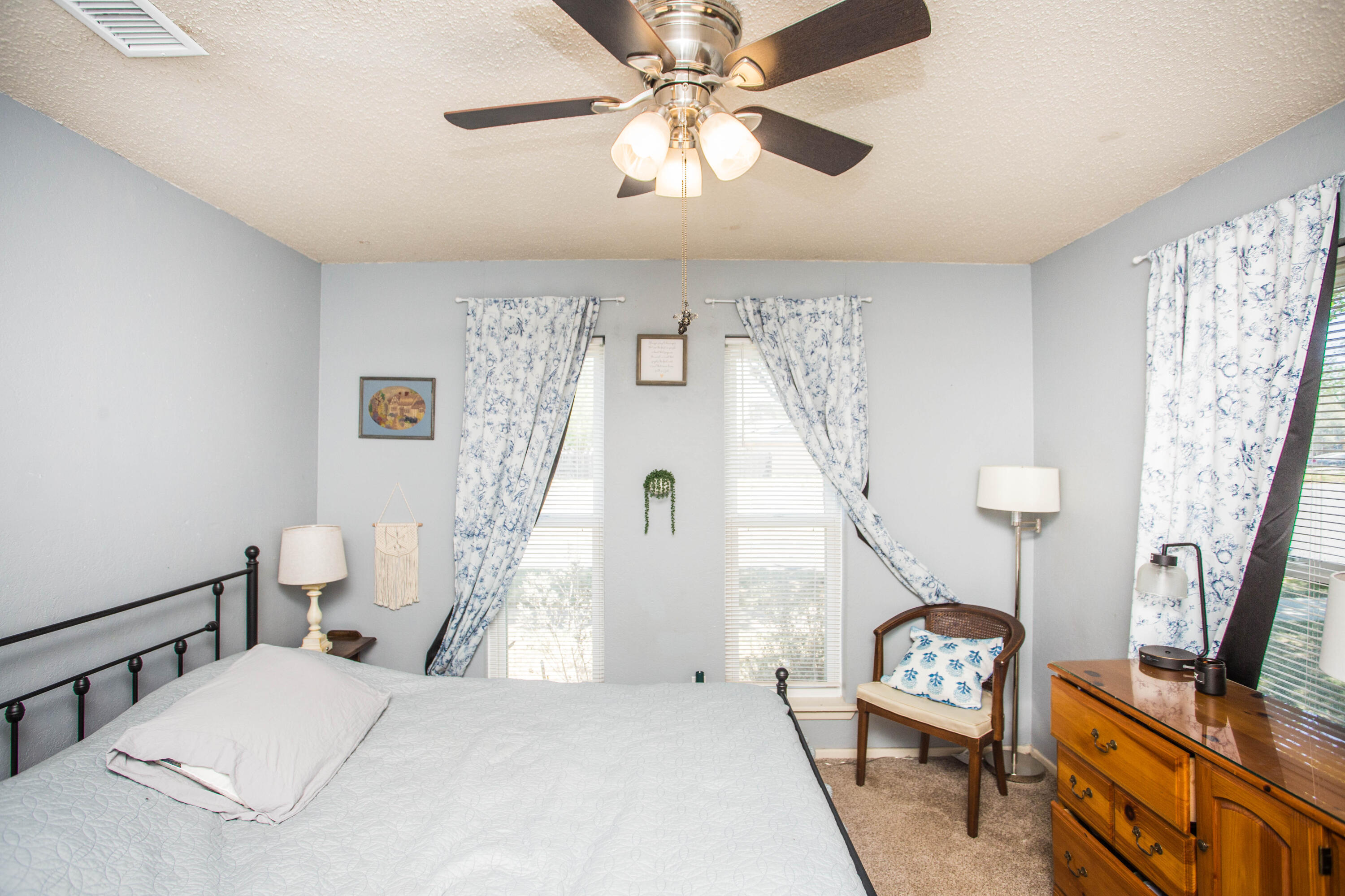 5202 44th Street Lubbock, TX 79414 - Photo 37 of 51 a bedroom with a bed and a chandelier