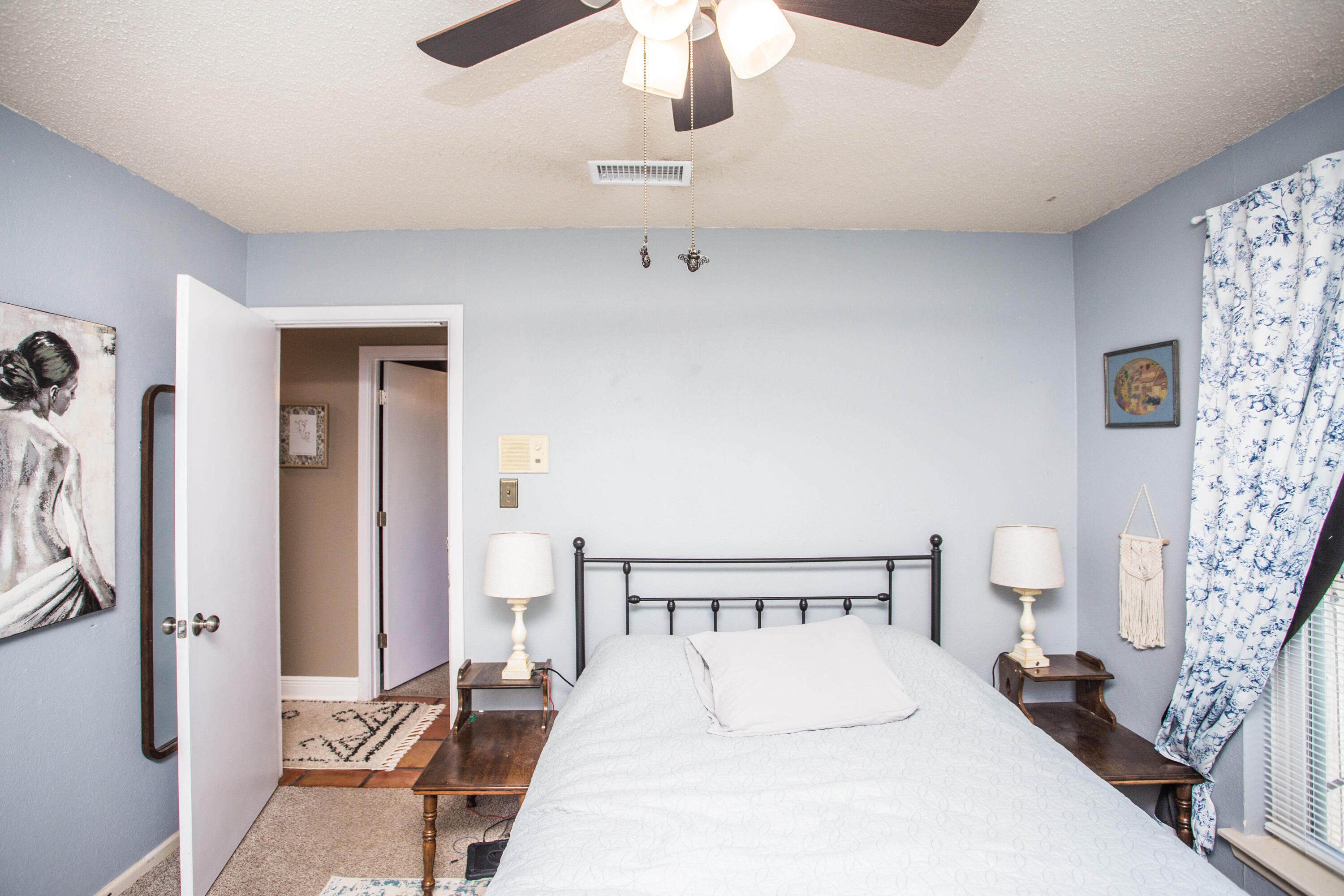 5202 44th Street Lubbock, TX 79414 - Photo 38 of 51 a bedroom with a bed and a chandelier