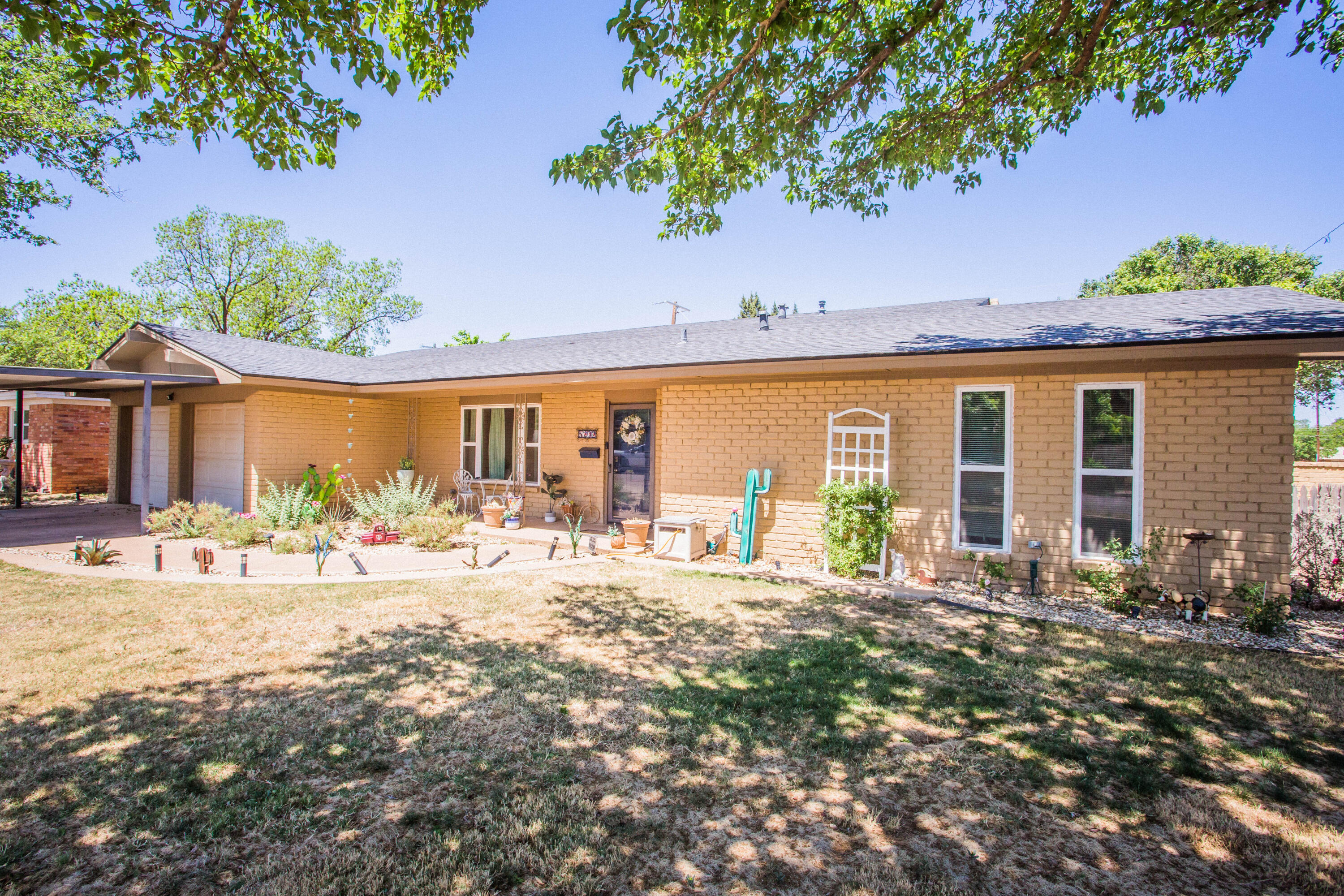 5202 44th Street Lubbock, TX 79414 - Photo 4 of 51 a front view of a house with outdoor seating