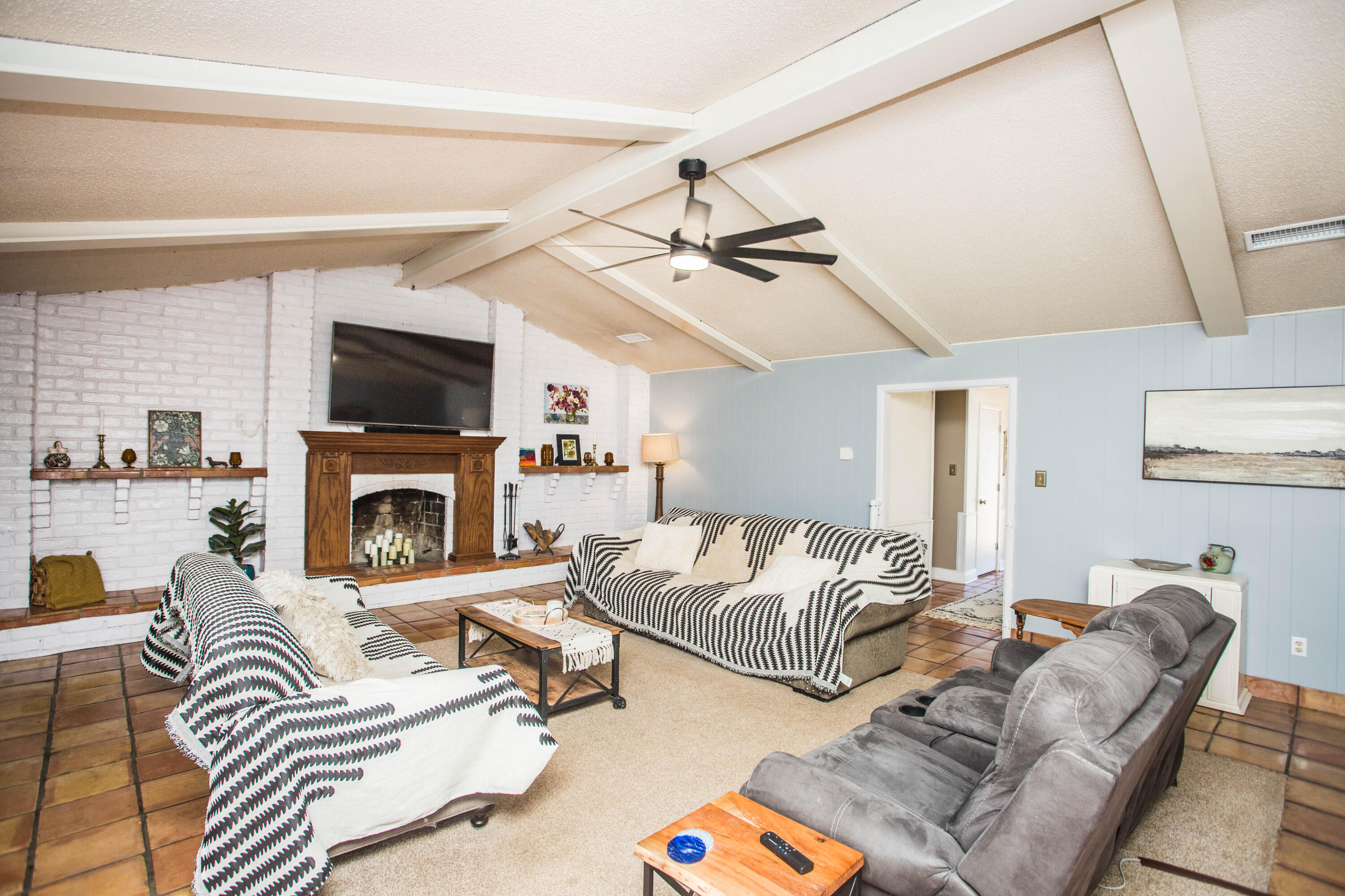 5202 44th Street Lubbock, TX 79414 - Photo 5 of 51 a living room with furniture a flat screen tv and a fireplace