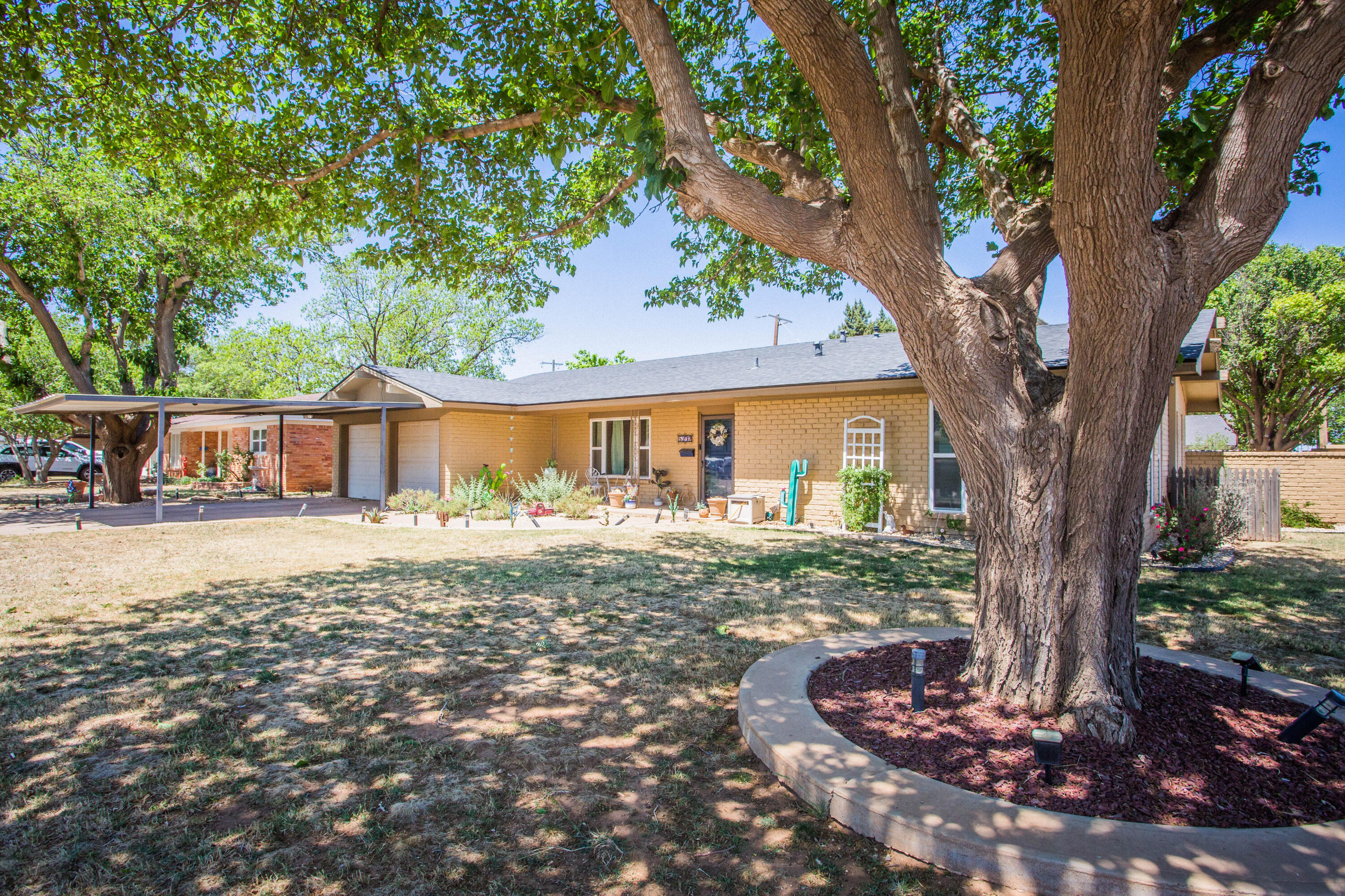 5202 44th Street Lubbock, TX 79414 - Photo 6 of 51 a front view of a house with a yard