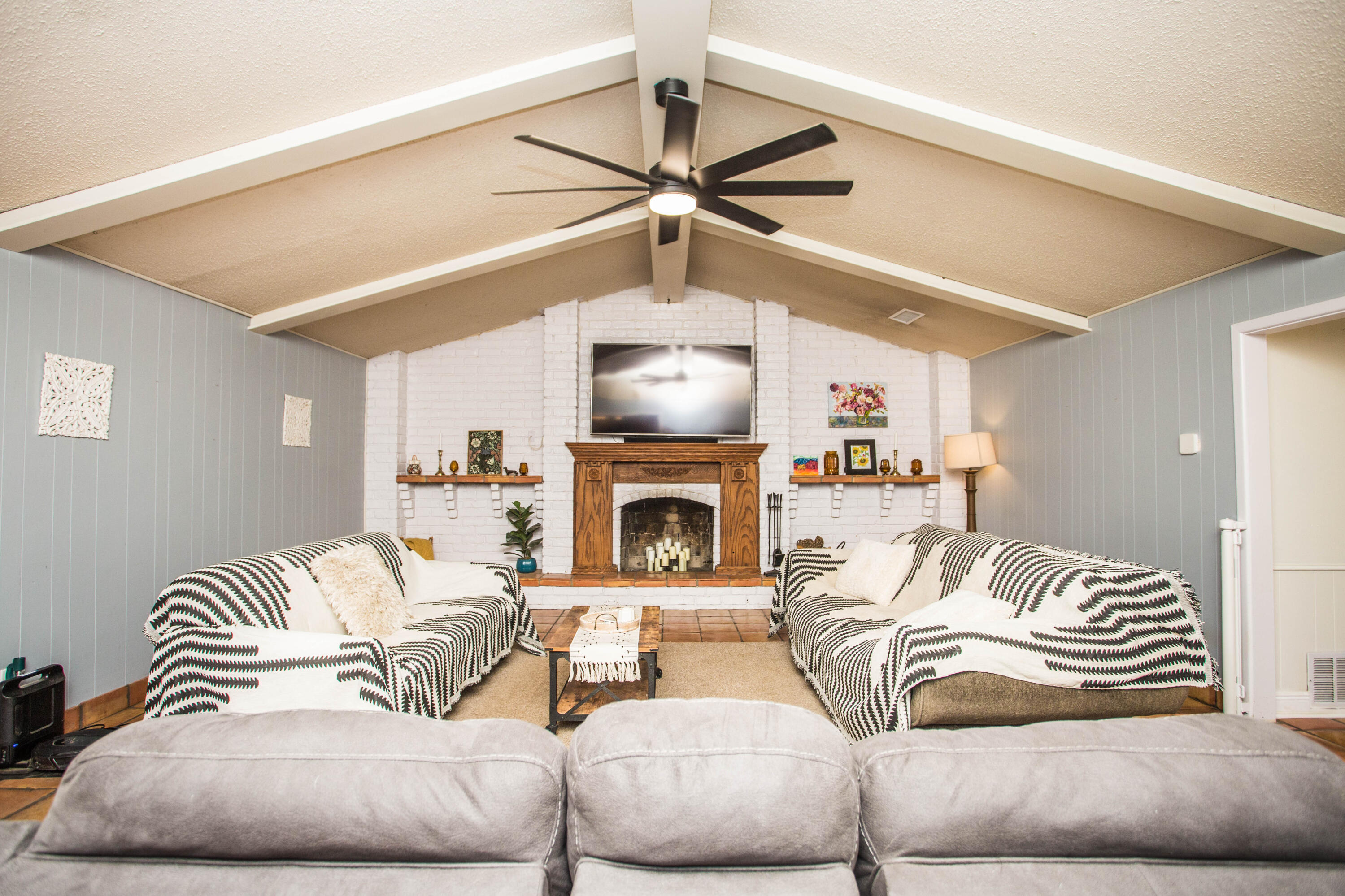 5202 44th Street Lubbock, TX 79414 - Photo 9 of 51 a living room with furniture a fireplace and a ceiling fan