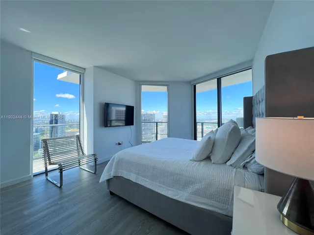 a bedroom with a bed and a television