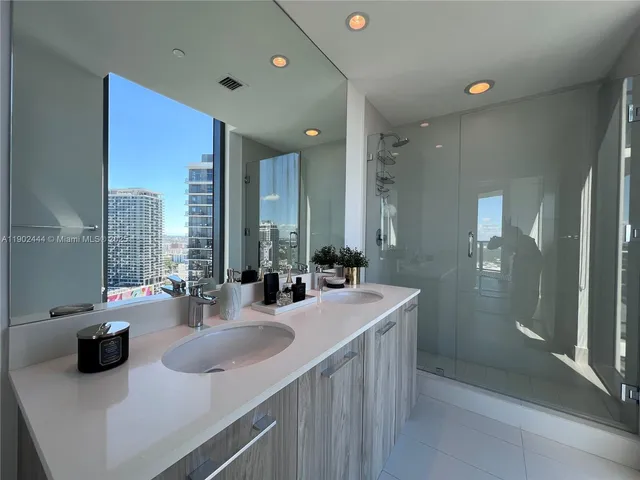 a bathroom with sink double vanity and a mirror