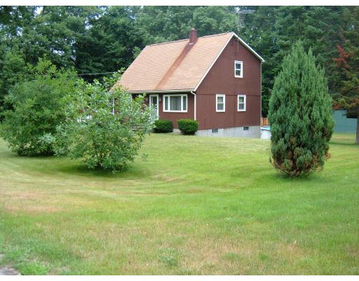 43 Hartness Road Sutton, MA 01590 - Photo 3 of 10 a view of a yard in front of a house with a large tree