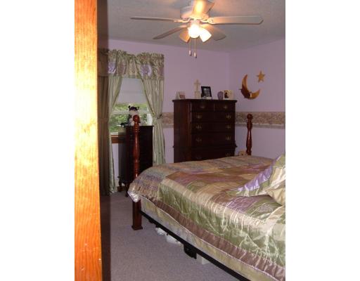 43 Hartness Road Sutton, MA 01590 - Photo 10 of 10 a bedroom with a bed and a chandelier