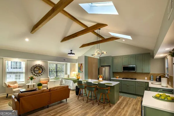 a large kitchen with a table chairs stove and cabinets