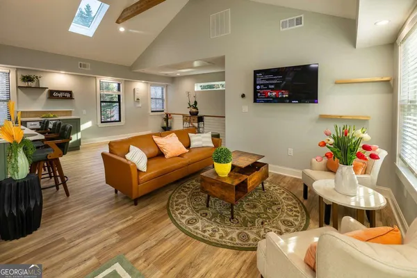 a living room with furniture and a flat screen tv