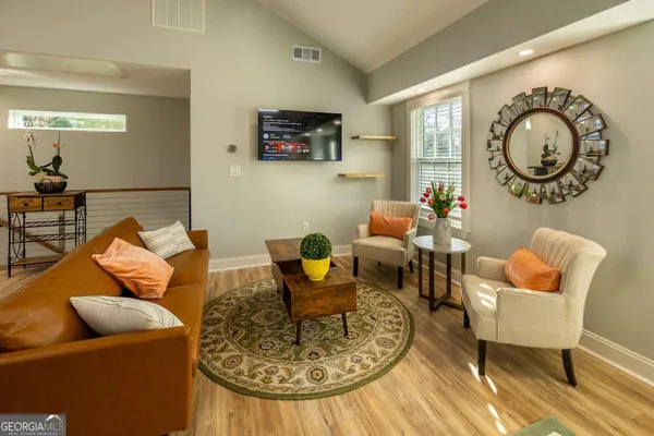 a living room with furniture and a mirror