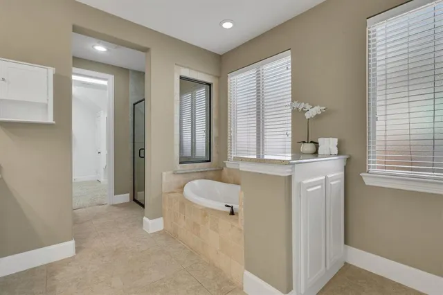 a spacious bathroom with a granite countertop sink and a mirror