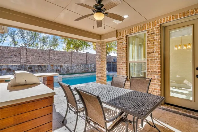 a view of a house with pool and chairs