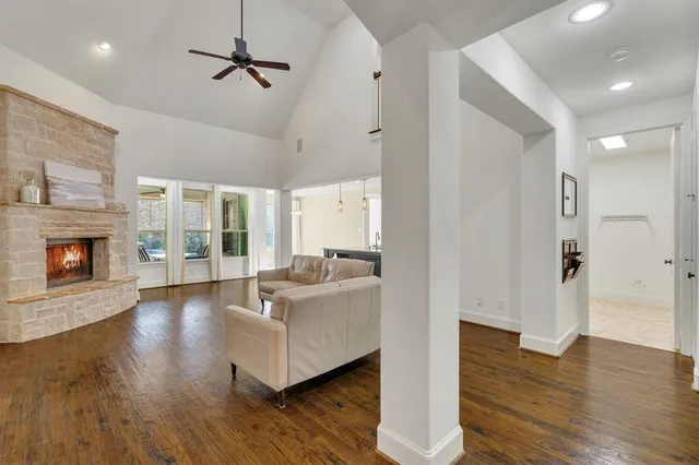 a living room with fireplace furniture and a wooden floor