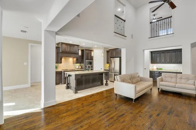 a living room with furniture and a wooden floor