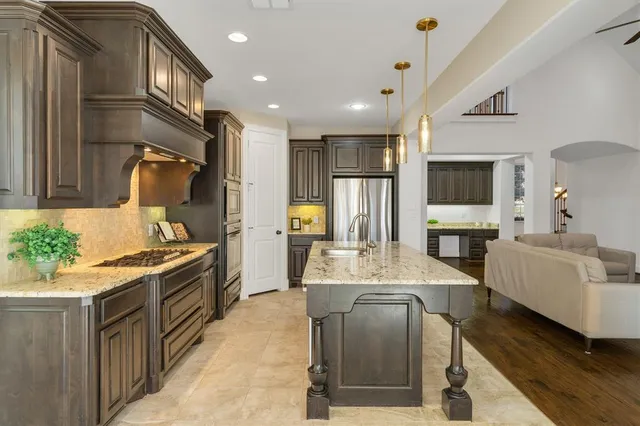 a kitchen with sink refrigerator and stove