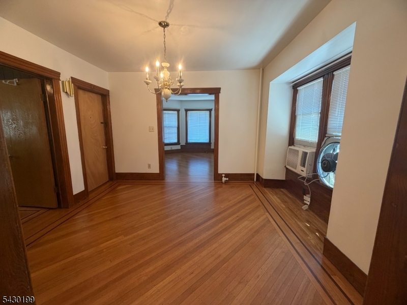 72 Baldwin Place, Unit 2 Bloomfield, NJ 07003 - Photo 5 of 24 a view of a room with wooden floor and staircase