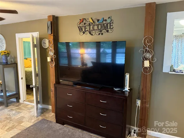 a room with furniture and flat screen tv