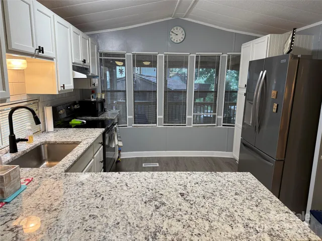 a kitchen with a refrigerator and a sink