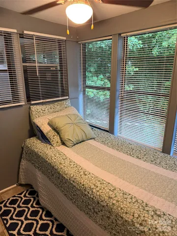 a bedroom with a bed and window