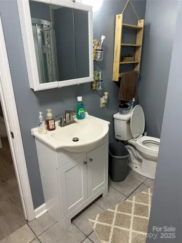 a bathroom with a sink toilet and mirror