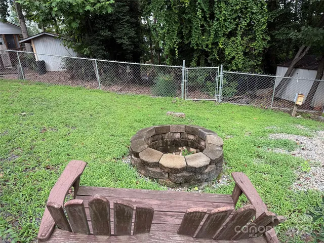 a view of a backyard with sitting area