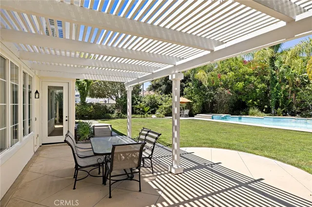 a patio with garden area and outdoor seating