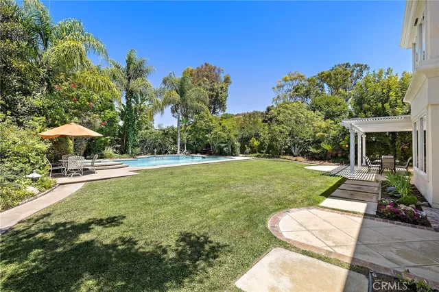 a view of a house with backyard sitting area and garden