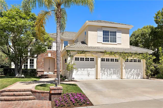 an aerial view of a house with a yard and garden