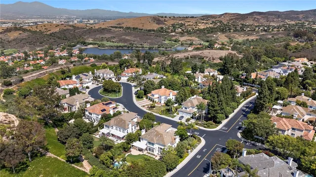 an aerial view of a house with a yard basket ball court and outdoor seating