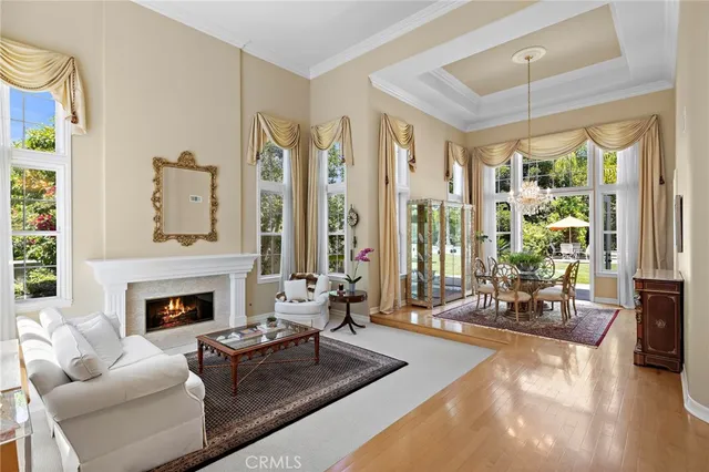 a living room with furniture large window and a fireplace