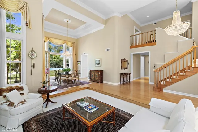 a living room with fireplace furniture and a large window