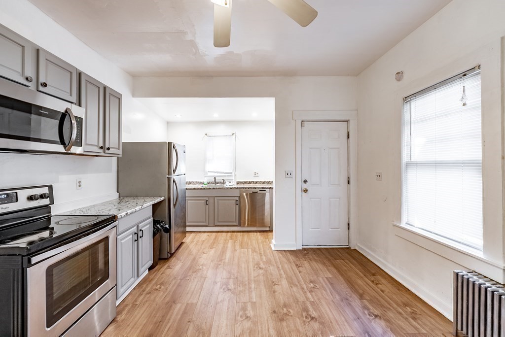 71 Mountainview Street Springfield, MA 01108 - Photo 6 of 21 a kitchen with a stove a sink and a microwave