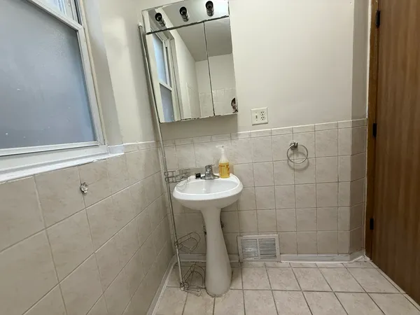 a bathroom with a sink a toilet and mirror