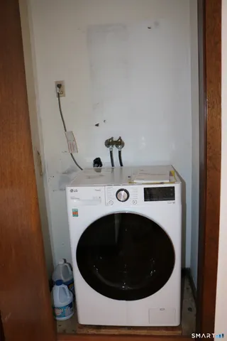 a room with a wooden floor and a sink