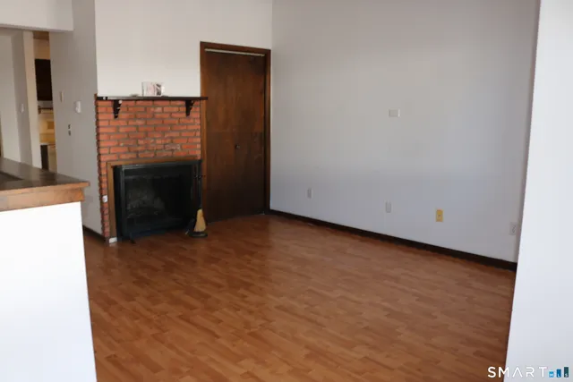 a view of an empty room with a fireplace