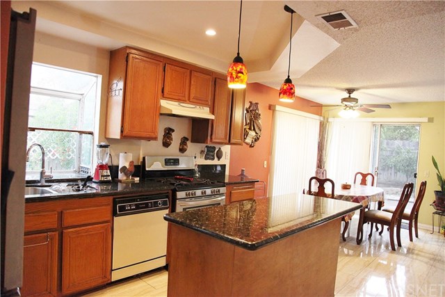 11545 Honeyglen Road Pacoima, CA 91331 - Photo 5 of 14 Big garden window, granite counter tops, designer lights, and island
