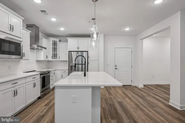 a kitchen with a sink appliances and cabinets