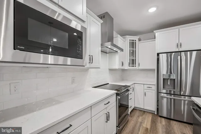 a view of kitchen with granite countertop cabinets and sink