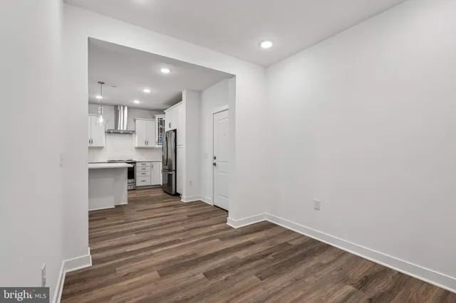 a view of a kitchen with a sink and a refrigerator