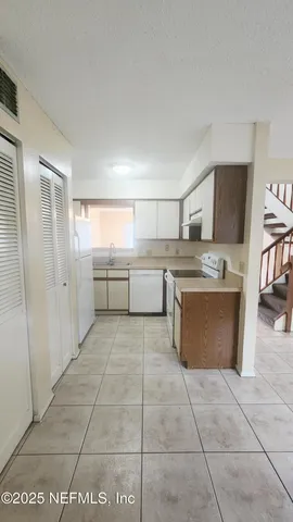 a large kitchen with kitchen island granite countertop a large counter top and appliances