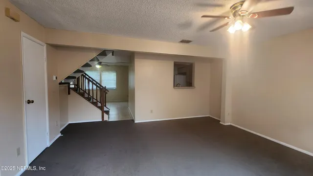 a view of an empty room with stairs