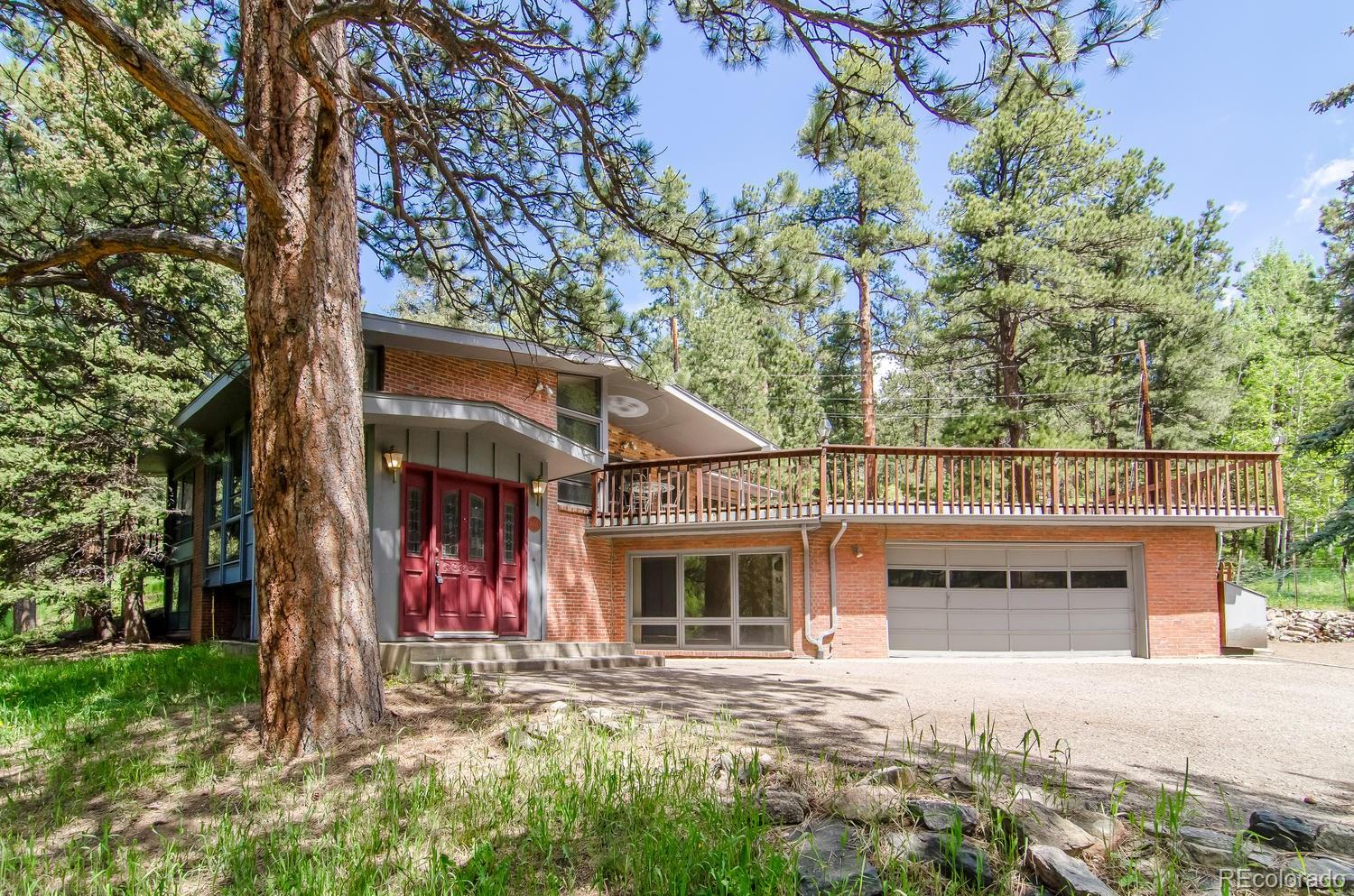 front view of a house with a tree in the background