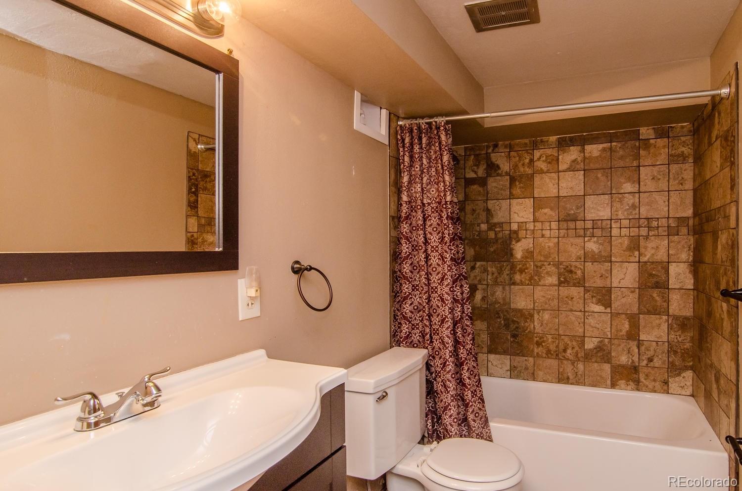 31463 Upper Bear Creek Road Evergreen, CO 80439 - Photo 19 of 23 a bathroom with a sink toilet and shower