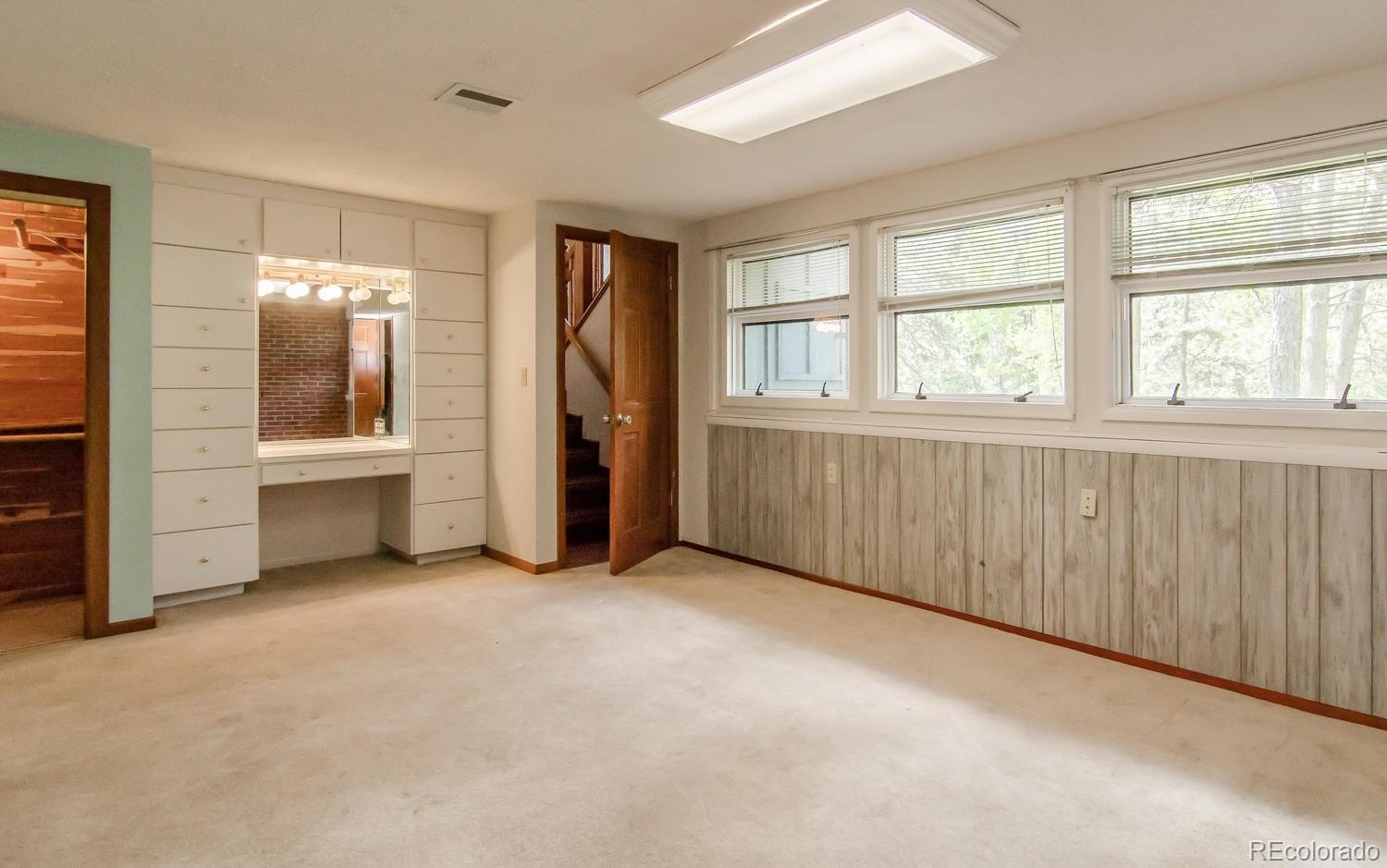 31463 Upper Bear Creek Road Evergreen, CO 80439 - Photo 21 of 23 an empty room with windows and closet