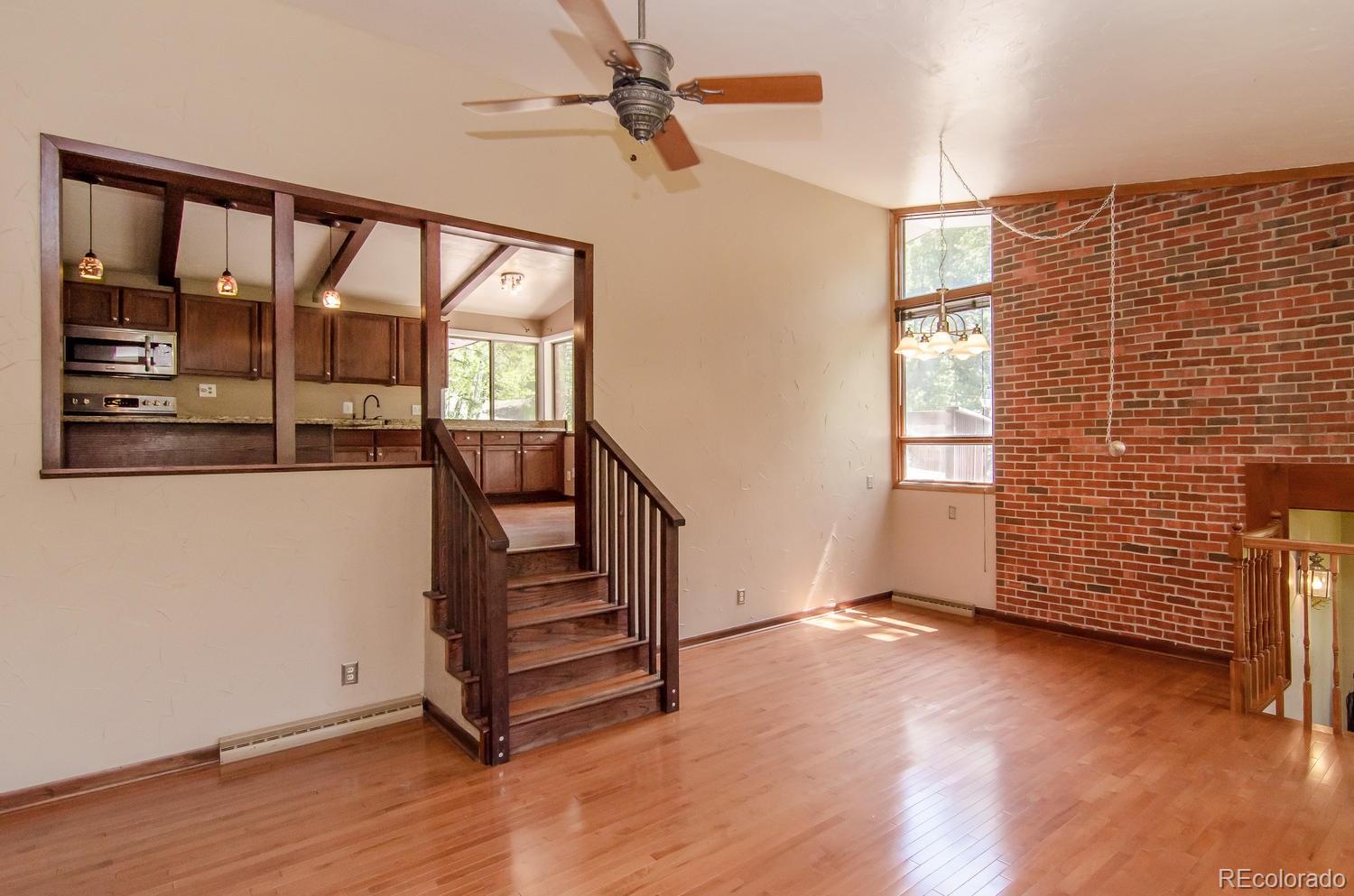 31463 Upper Bear Creek Road Evergreen, CO 80439 - Photo 7 of 23 wooden floor in an empty room with a window